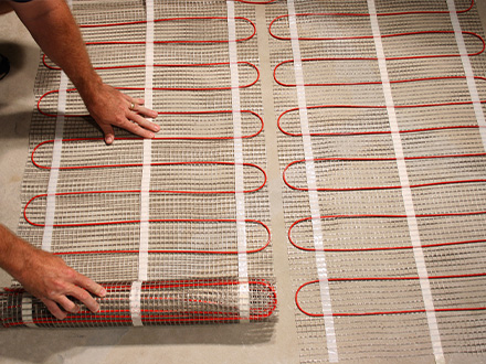 Floor heating cable being installed to heat floor.