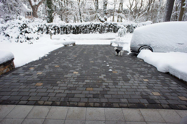 A radiant heated driveway with brick pavers.